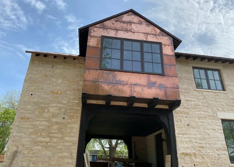 Copper metal panel facade on a stone building for Metal Roof Coating in Russellville